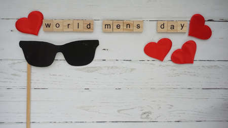 World mens day. lettering cleaning mask mustache gifts heart on a beautiful backgroundの写真素材