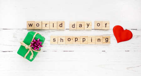 World day of shopping. words from wooden cubes with letters