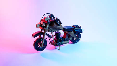 wooden motorcycle toy. red and blue illumination, cyberpunk.の写真素材