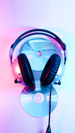 headphones and a CD. red and blue illumination, cyberpunk.