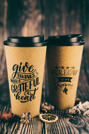 a cup for coffee or tea on a beautiful wooden background. thermo mug
