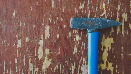 the hammer is lying on a wooden table