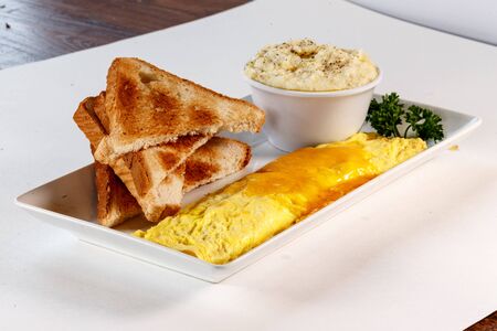 omelet with toast and grits