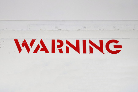 Red WARNING Sign on White Metalの写真素材