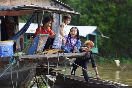 Siem Reap, Cambodia - Jan 23, 2012: Unidentified children playing on their house boat on Tonle Sap Lake in Siem Reap, Cambodia on January 23, 2012.のeditorial素材