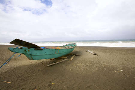Green Wooden Boat on Ocean Sand Beachの写真素材