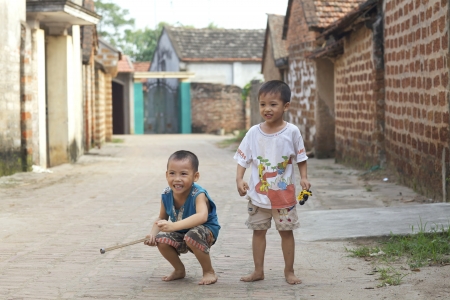 Duong Lam Village, Vietnam- Sept 3: Unidentified Vietnamese children playing in streets of Duong Lam Village, Vietnam on September 3, 2010.のeditorial素材