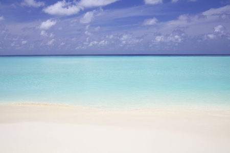 Blue ocean water with sand beachの写真素材