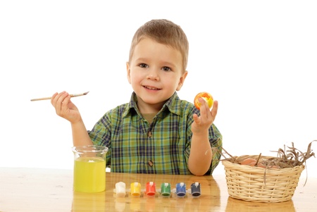 Little child painting the easter eggs