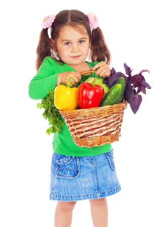 Little girl with basket of vegetables, isolated on whiteの写真素材