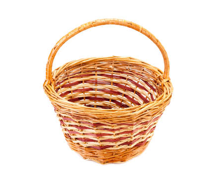 Empty yellow wicker basket, isolated on whiteの写真素材