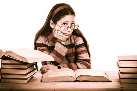 sad girl with pile of old books, sepia toned, isolated on white