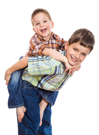 Two brothers playing together, isolated on whiteの写真素材