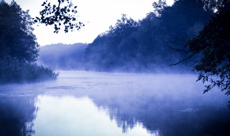 Morning fog on a calm river, tranquil scene on Seversky Donets river, Ukraine, cold color toned imageの写真素材