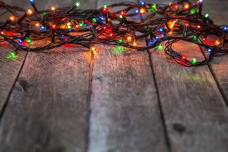 Christmas lights on wooden background, abstract template with selective focusの写真素材