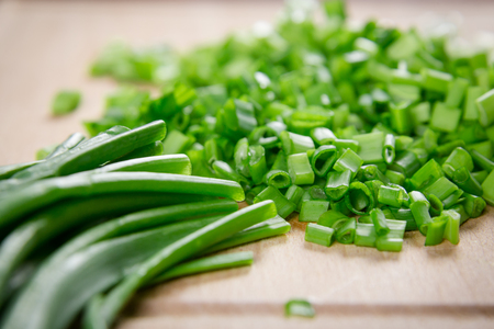 Chopped green onion on cutting board, food backgroundの写真素材