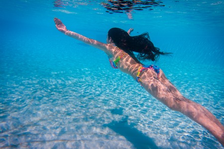Girl dive in the swimming pool, underwater shootの写真素材