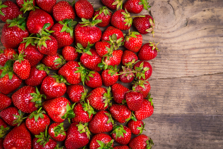 plenty of ripe strawberry on wood table, natural food backgroundの写真素材