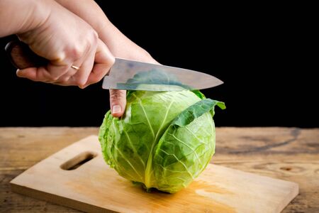 Cut cabbage into two parts on wooden cutting boardの写真素材