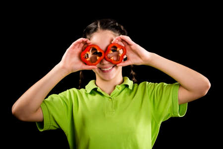 funny girl with sliced paprika on eyesの写真素材