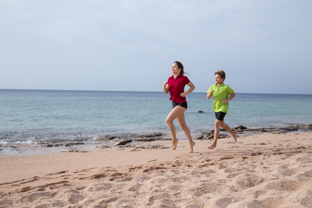 Two kids running together at morning exersisesの写真素材