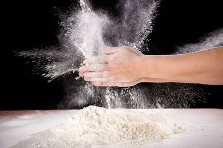 chefs hand clapping with powder flour when kneading the doughの写真素材