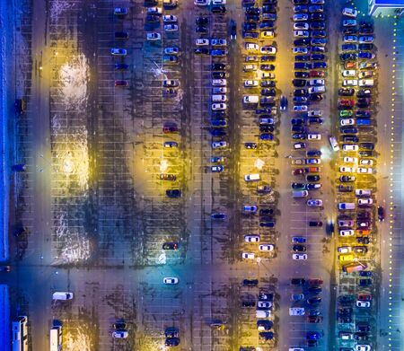 Winter evening aerial view to parking lot near supermarket
