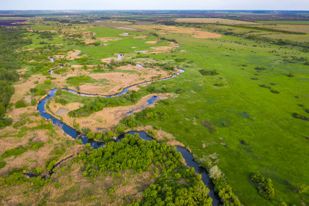 Aerial view to green spring landscape with meadow and Seversky Donets river bend, Kharkiv region,...