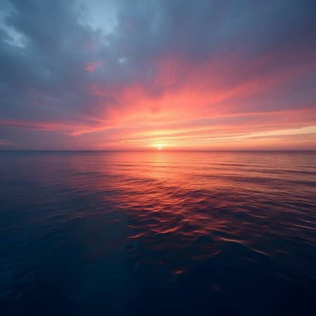Sunset over the sea. Beautiful sky with clouds reflected in water.の素材