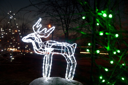 Glowing white deer, on a black background, neon illumination Christmasの写真素材