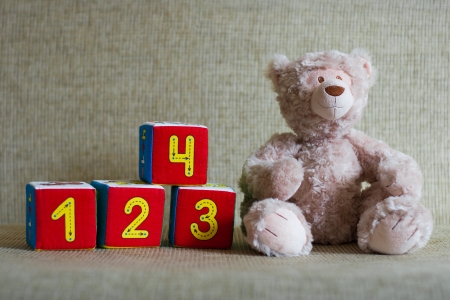 Teddy bear and cubes with number one, two, three, four