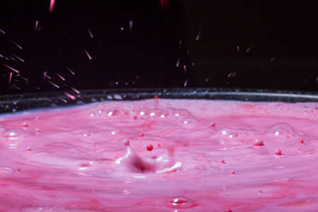 Splash of milk drop in pink and red color.