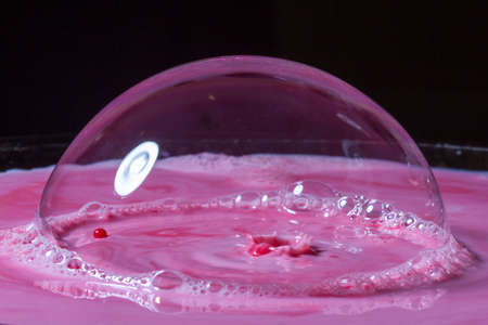 Splash of milk drop in pink and red color.