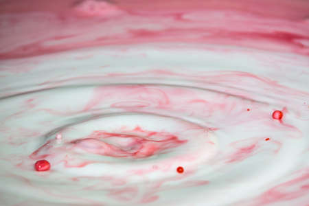 Splash of milk drop in pink and red color.