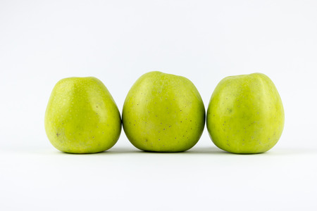 Three green apples, isolated on a white backgroundの写真素材