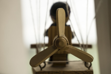 Wooden puppet in a balloon, looking out the window.の写真素材