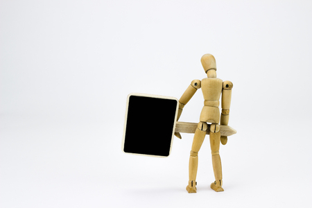 Wooden man with sign in front of white backgroundの写真素材