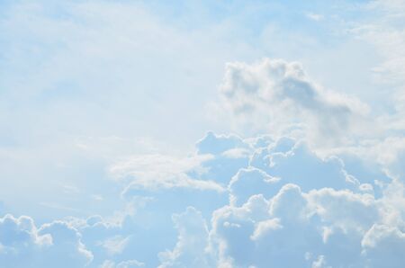 Cumulus Clouds In The Blue Sky Backlit By The Daytime Summer Sunの写真素材