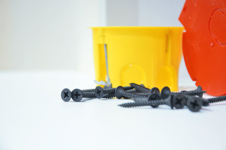 Plastic electrical boxes and self-tapping screws for socket boxes for conducting wires to switches and sockets.の写真素材