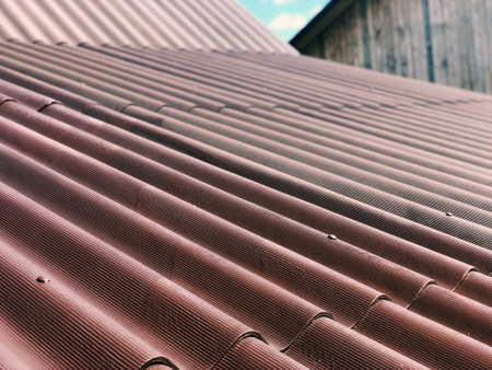 Dried brown paint applied to new slate on the roof of a houseの写真素材