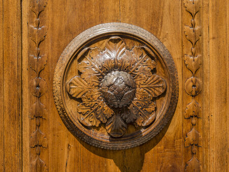 Wooden door in Arezzo in the foreground with a rosette,の写真素材