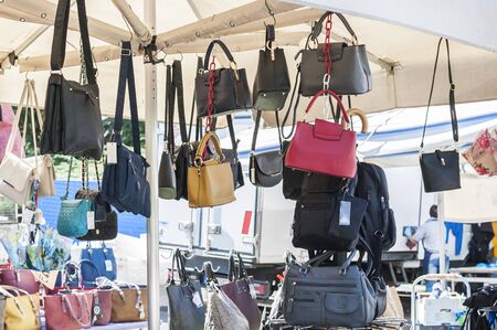 Women's handbags for sale at an outdoor marketの写真素材