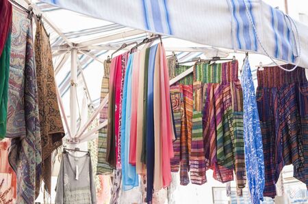 Shawl Women for sale at outdoor market. Italy