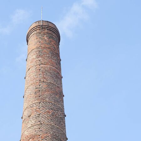 Smokestack of an old abandoned industrial complexの写真素材