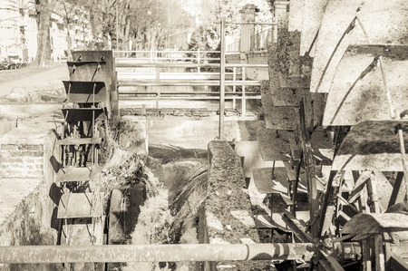 Old iron wheel a watermill. Ruins of a watermill. Effect vintage.の写真素材