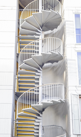 Spiral staircase serving as fire escape .Emergency exit outside building.の写真素材