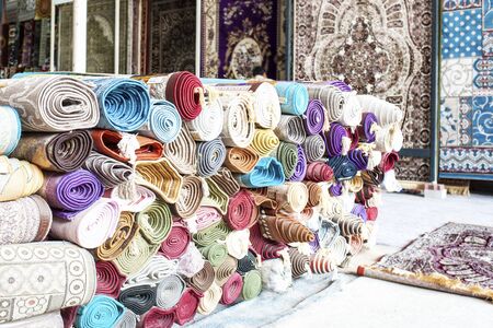 Many colorful carpets for sale  in the store.