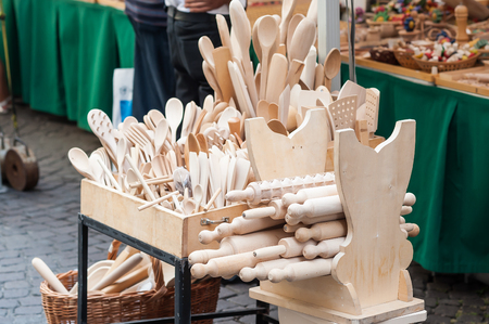 Handmade wooden, vintage kitchen utensils for sale at the market. Various wooden kitchen tools. Different wooden tableware.の写真素材
