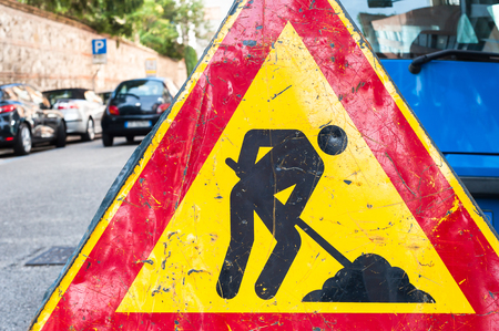 Road signs in a street under reconstruction symbol.の写真素材