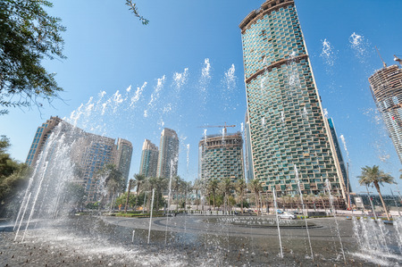 View of Dubai. Skyscrapers, fountains and palm trees.